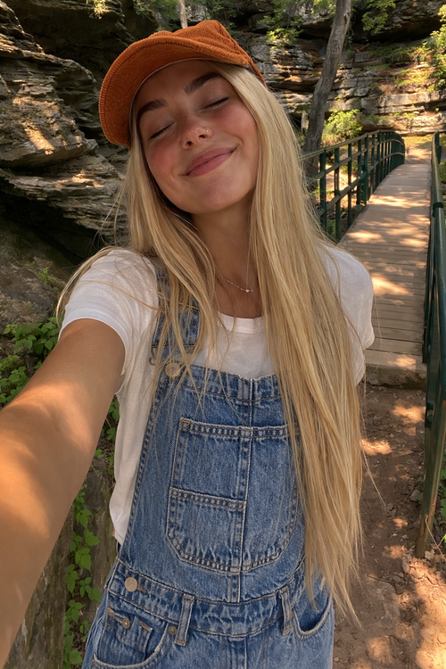 Baggy denim overalls for women in classic blue wash, front view with adjustable straps