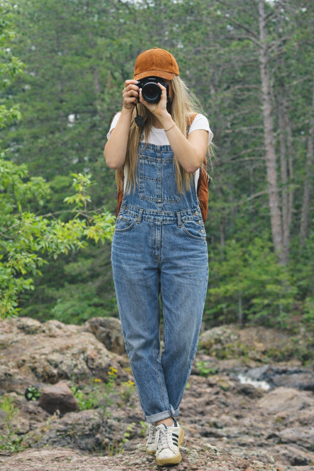 Side view of women's baggy jean overalls showing relaxed wide-leg silhouette