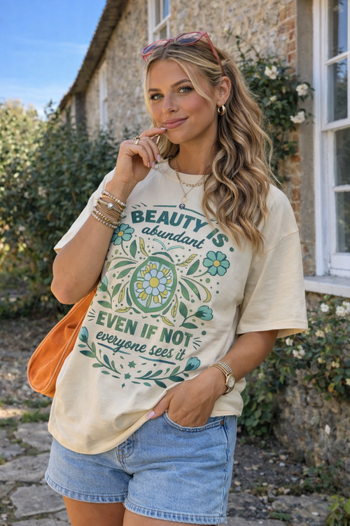 Spring floral quote shirt featuring Beauty Is Abundant design with turquoise flowers and botanical details